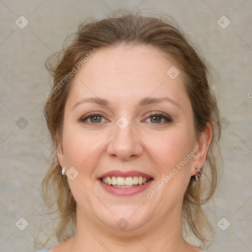 Joyful white adult female with medium  brown hair and grey eyes