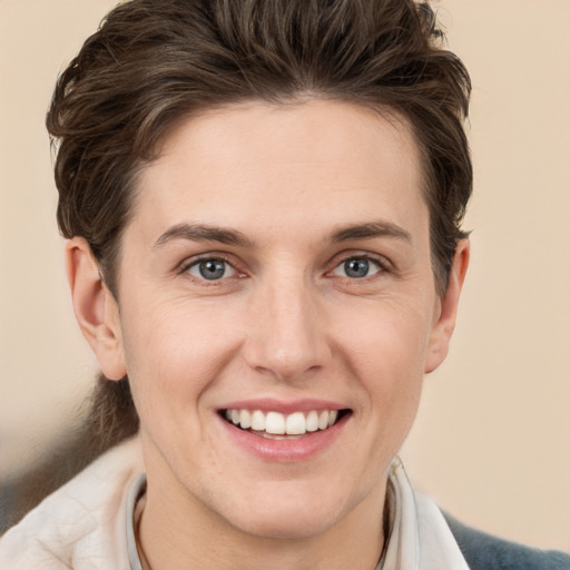 Joyful white young-adult female with short  brown hair and grey eyes