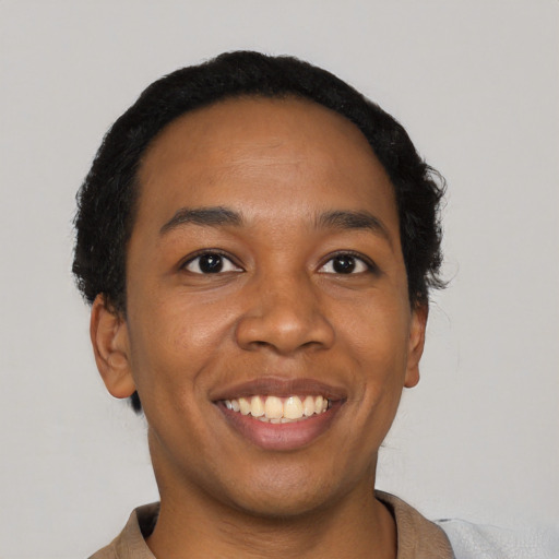 Joyful latino young-adult female with short  black hair and brown eyes