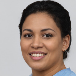 Joyful latino young-adult female with short  brown hair and brown eyes