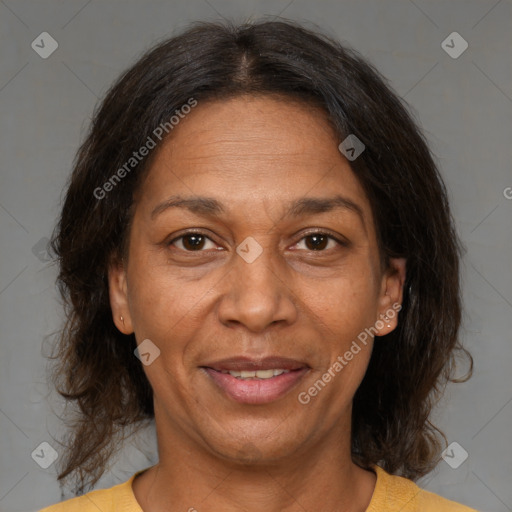 Joyful black adult female with medium  brown hair and brown eyes