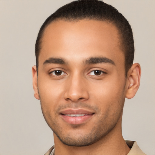 Joyful latino young-adult male with short  brown hair and brown eyes