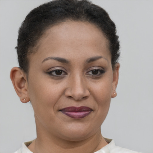 Joyful latino young-adult female with short  brown hair and brown eyes