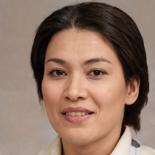 Joyful white adult female with medium  brown hair and brown eyes