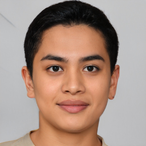 Joyful latino young-adult male with short  brown hair and brown eyes