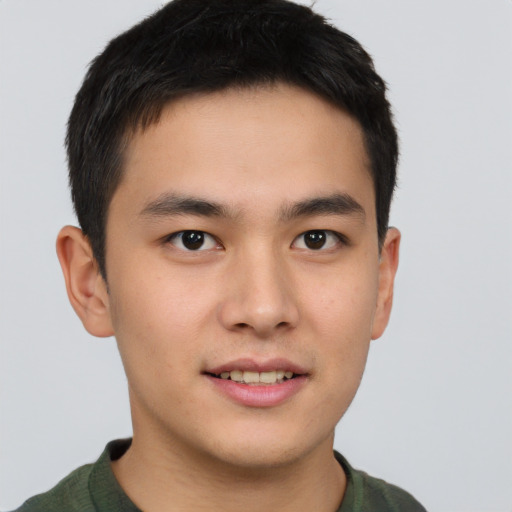 Joyful asian young-adult male with short  brown hair and brown eyes