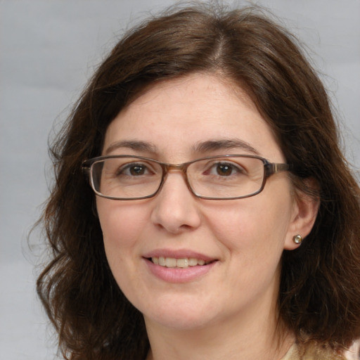 Joyful white adult female with medium  brown hair and brown eyes