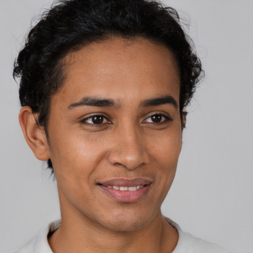 Joyful latino young-adult male with short  brown hair and brown eyes