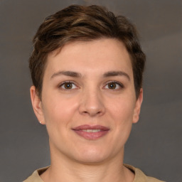 Joyful white young-adult female with short  brown hair and grey eyes