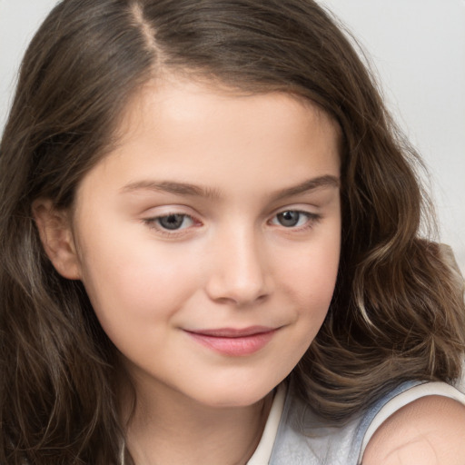 Joyful white child female with long  brown hair and brown eyes