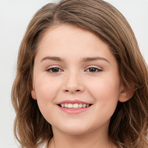 Joyful white child female with long  brown hair and brown eyes