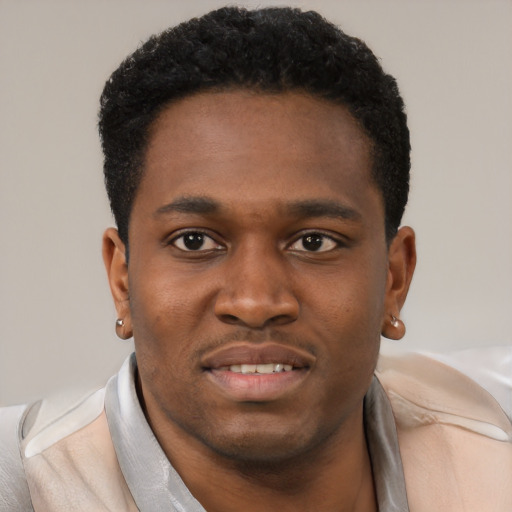 Joyful black young-adult male with short  black hair and brown eyes