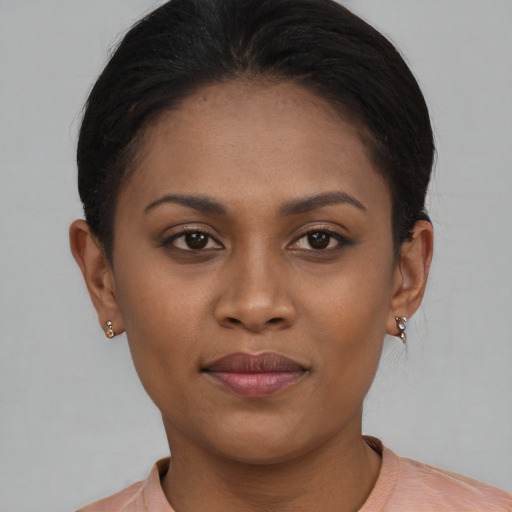 Joyful black young-adult female with short  brown hair and brown eyes
