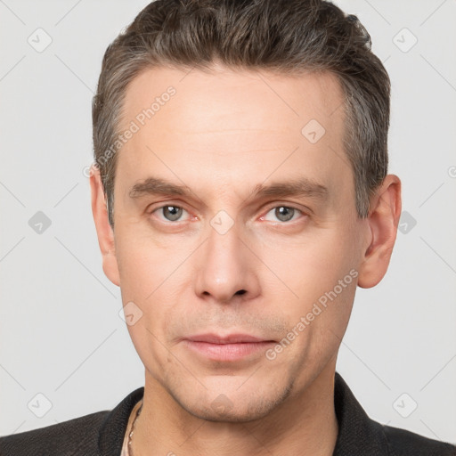 Neutral white adult male with short  brown hair and grey eyes