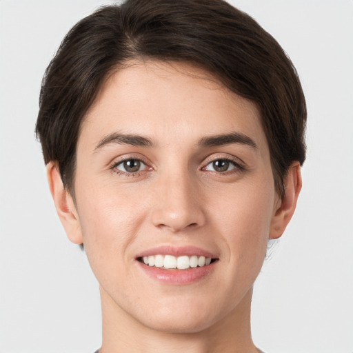 Joyful white young-adult female with short  brown hair and brown eyes