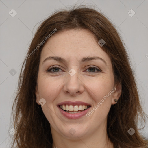 Joyful white adult female with long  brown hair and brown eyes