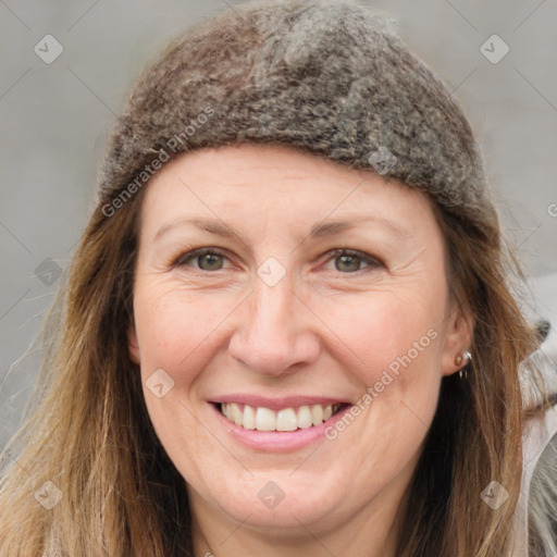 Joyful white adult female with long  brown hair and grey eyes