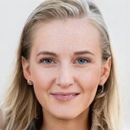 Joyful white young-adult female with long  brown hair and blue eyes