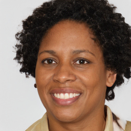 Joyful black adult female with short  brown hair and brown eyes