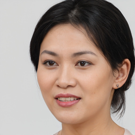 Joyful asian young-adult female with medium  brown hair and brown eyes
