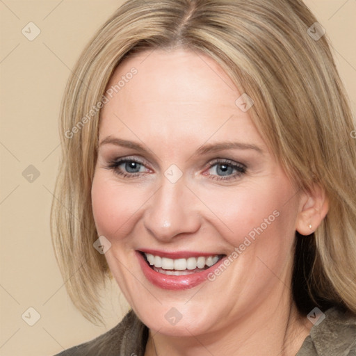 Joyful white adult female with medium  brown hair and blue eyes