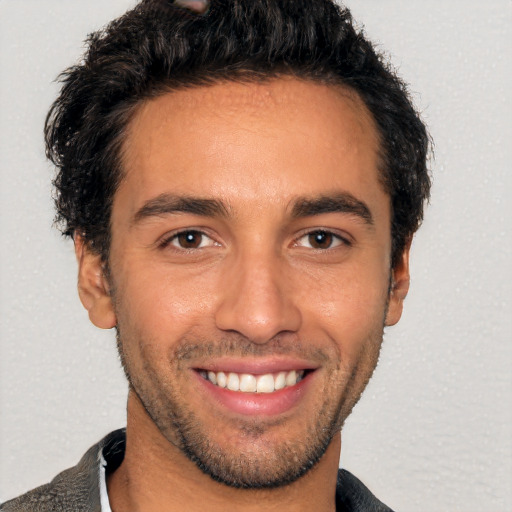 Joyful white young-adult male with short  black hair and brown eyes