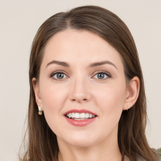 Joyful white young-adult female with long  brown hair and grey eyes