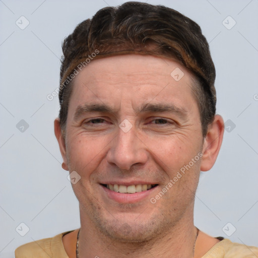 Joyful white adult male with short  brown hair and brown eyes