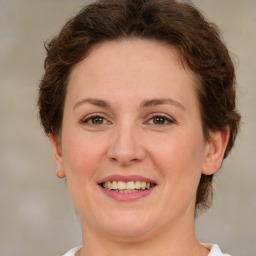 Joyful white young-adult female with medium  brown hair and green eyes