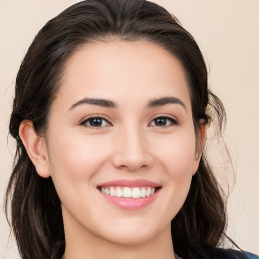 Joyful white young-adult female with long  brown hair and brown eyes