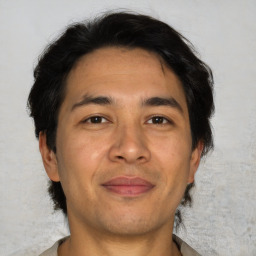 Joyful asian adult male with short  brown hair and brown eyes