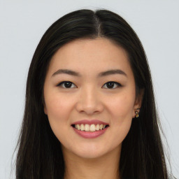 Joyful asian young-adult female with long  brown hair and brown eyes