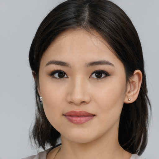 Joyful asian young-adult female with medium  black hair and brown eyes
