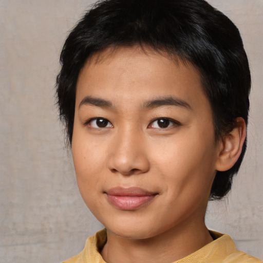 Joyful asian young-adult female with medium  black hair and brown eyes