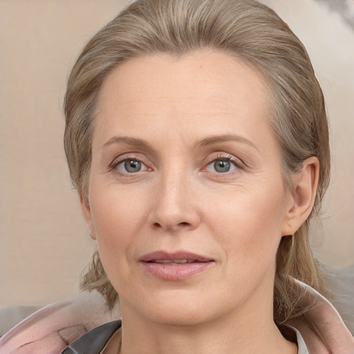 Joyful white adult female with medium  brown hair and grey eyes