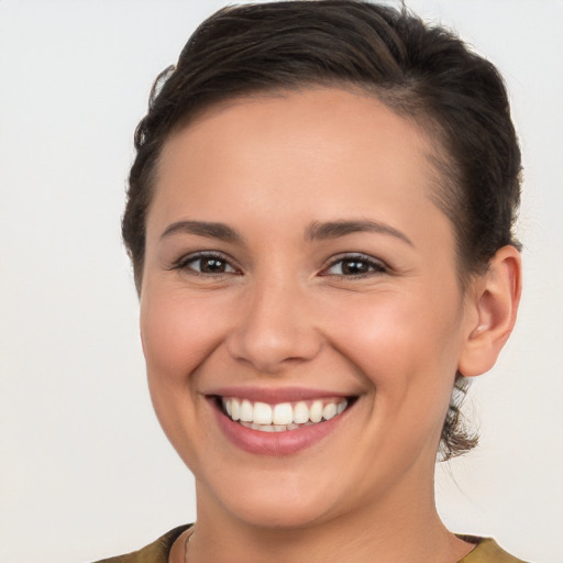 Joyful white young-adult female with short  brown hair and brown eyes