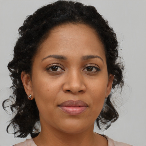 Joyful latino adult female with medium  brown hair and brown eyes