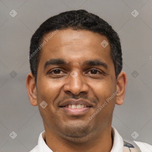 Joyful latino adult male with short  black hair and brown eyes