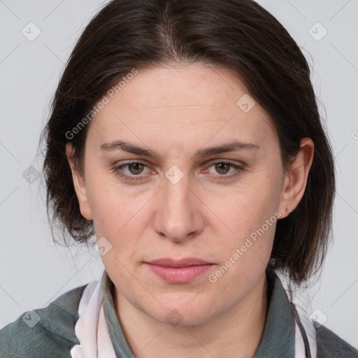 Joyful white adult female with medium  brown hair and grey eyes