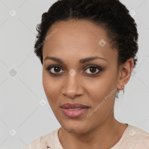 Joyful black young-adult female with short  brown hair and brown eyes