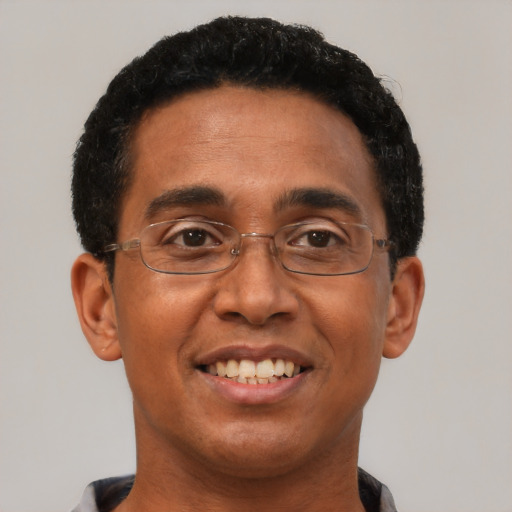 Joyful black adult male with short  brown hair and brown eyes