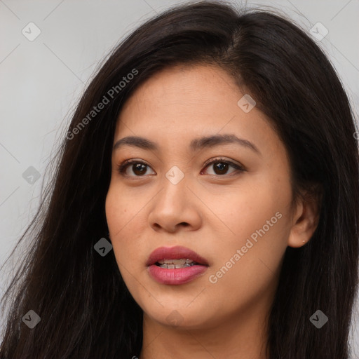 Joyful latino young-adult female with long  brown hair and brown eyes