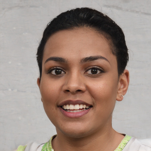 Joyful white young-adult female with short  black hair and brown eyes