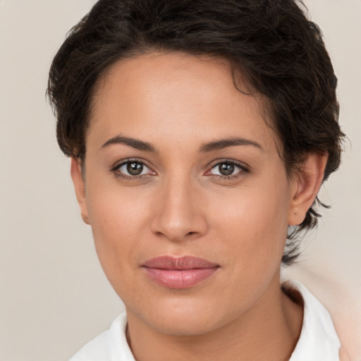 Joyful white young-adult female with short  brown hair and brown eyes