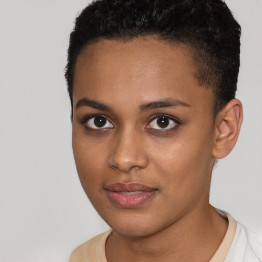 Joyful black young-adult female with short  brown hair and brown eyes