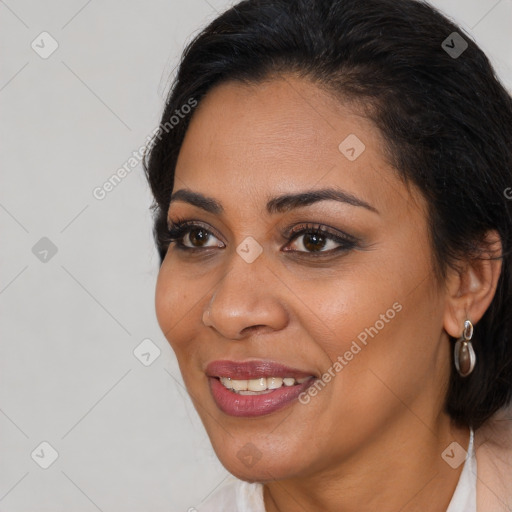 Joyful latino young-adult female with long  brown hair and brown eyes