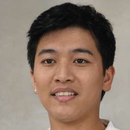 Joyful asian young-adult male with short  black hair and brown eyes