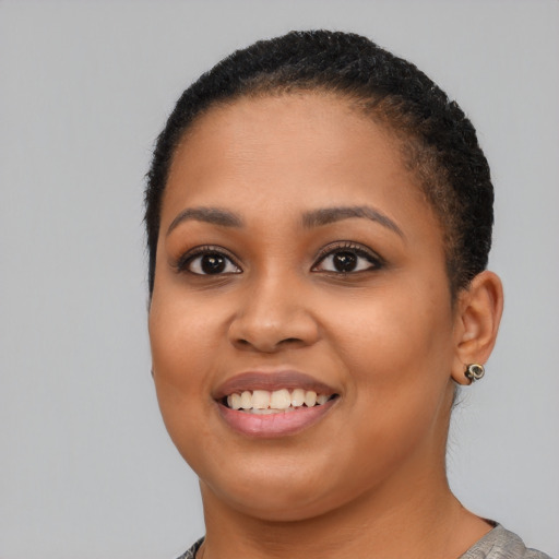 Joyful latino young-adult female with short  black hair and brown eyes