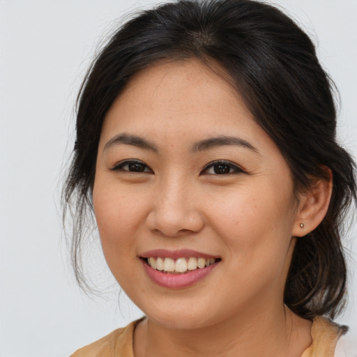 Joyful asian young-adult female with medium  brown hair and brown eyes