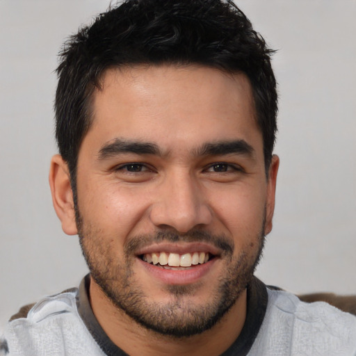 Joyful white young-adult male with short  black hair and brown eyes